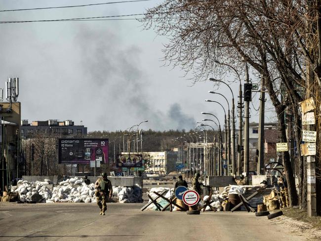 Ukrainian servicemen stand at a check point in Kyiv. Picture: AFP