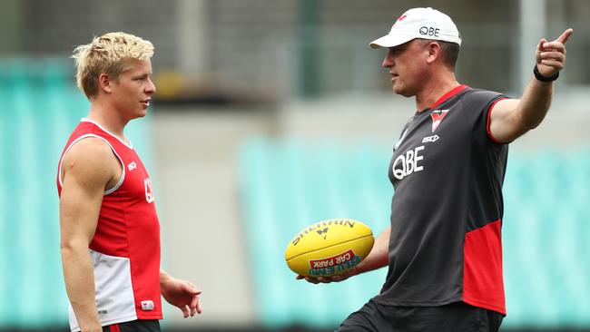 Isaac Heeney, left, with coach John Longmire in the lead-up to the Round 2 clash with the Crows.