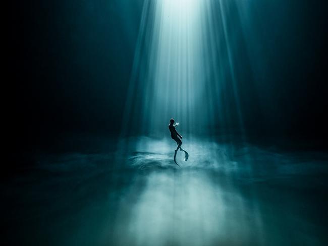 In the silence interrupted only by air bubbles, a freediver trains in a freshwater abyss in Mexico. The sulphur cloud beneath him reflects the sun’s rays, creating an extraordinary visual effect: initially, it appears solid, but then dissolves like clouds once passed through. Picture: Fabrice Guerin