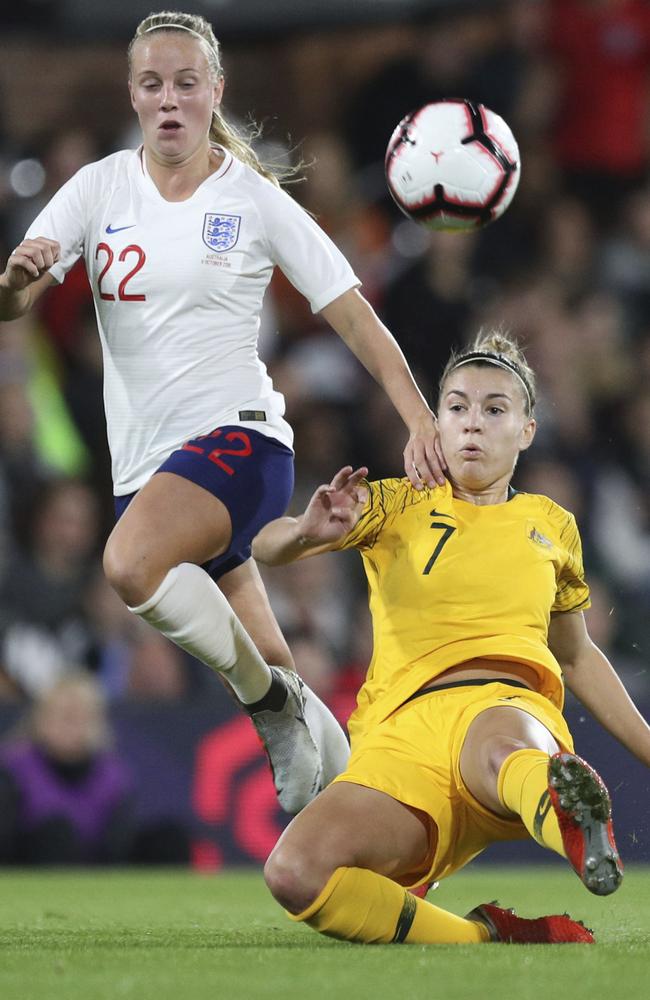 Steph Catley tries to come to grips with Beth Mead. Picture: AP.