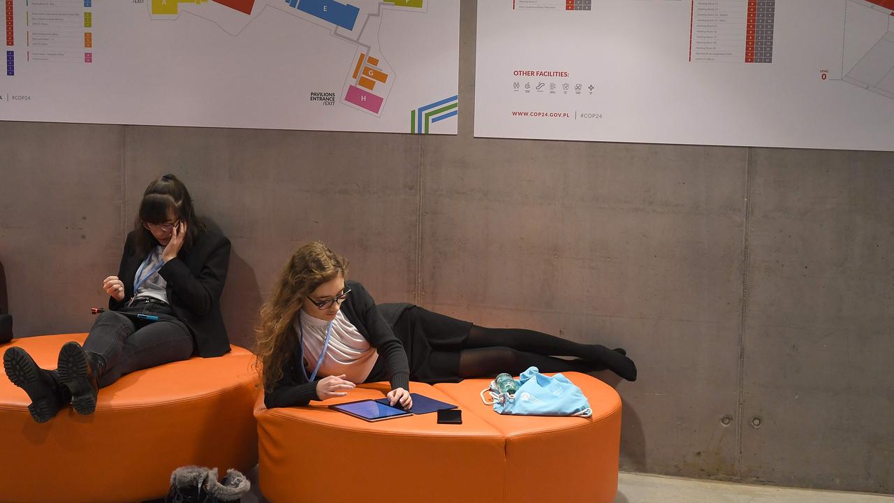 Participants take some rest before the end of the final session of the COP24 summit on climate change in Katowice, Poland. Picture: AFP 