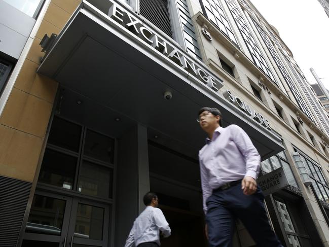 Pedestrians walk past the ASX Ltd. exchange centre in Sydney, Australia, on Thursday, Feb. 14, 2019. “We made good progress on our core initiatives across the period, including the program to replace CHESS with distributed ledger technology; upgrade of our secondary data centre to strengthen market resilience; and restructure of our Listings Compliance team to enhance the quality of market oversight,” ASX Chief Executive Officer Dominic Stevens said. Photographer: David Moir/Bloomberg