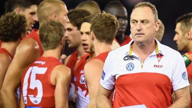 Swans coach John Longmire and his players during the match against the Bulldogs.