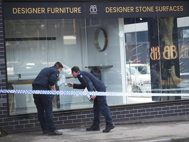 Police at the designer stone surface shop in Richmond. Picture: David Crosling