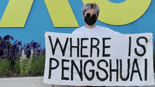 A fan holds a Peng Shuai banner at Melbourne Park.