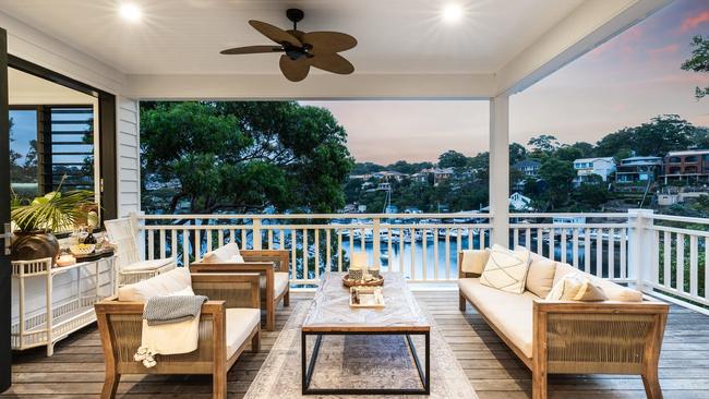 The three-level, five-bedroom home on the 925sq m holding on the Port Hacking River has a number of wraparound balconies that overlook the bay. Picture: realestate.com.au