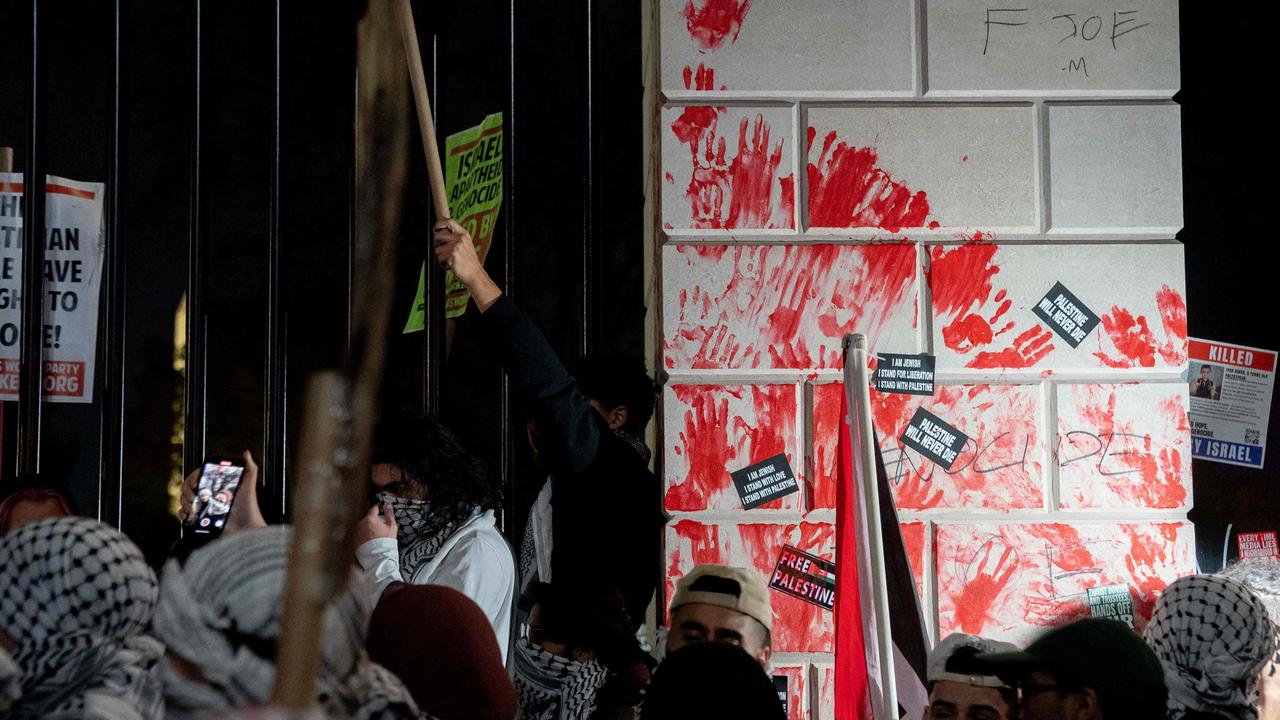 Demonstrators smeared red hand prints on the fence in front of the White House. Picture: Stefani Reynolds/AFP