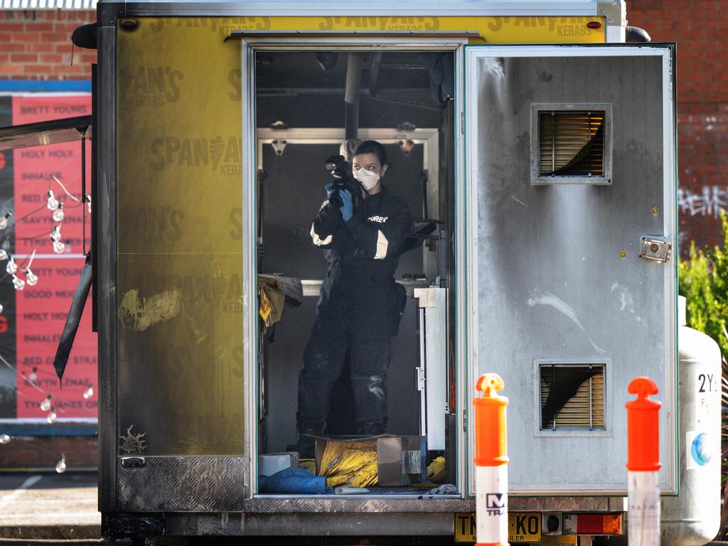 Forensic investigators at the scene of the fire on Saturday. Picture: Tony Gough