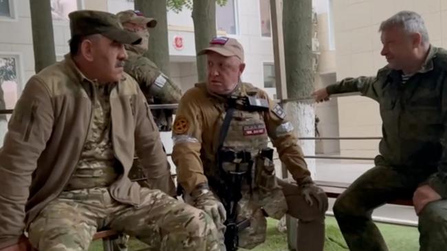 This video grab taken from handout footage posted on Saturday. It shows Wagner Group chief Yevgeny Prigozhin (centre) speaking with Lieutenant General Vladimir Alekseev (right) and Russian Defense Deputy Minister Yunus-Bek Evkurov (left) inside the headquarters of the Russian southern military district in the city of Rostov-on-Don. Picture: AFP