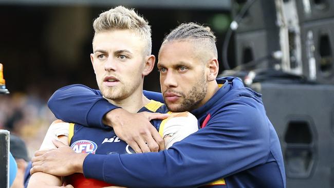 Crows midfielder Hugh Greenwood commiserates with injured Crow Cam Ellis-Yolmen. Picture: Sarah Reed