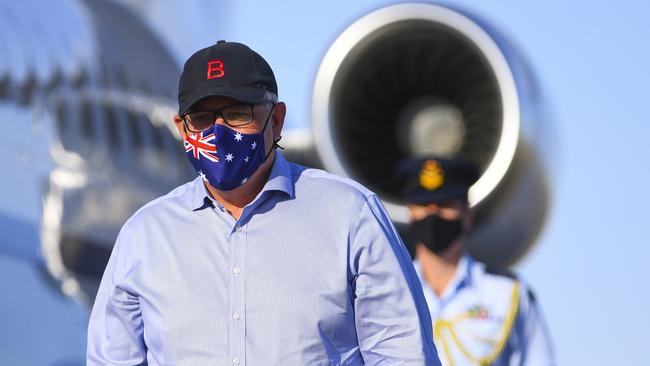 Scott Morrison wears a face mask as he disembarks a plane after landing at Longreach Airport in Queensland this morning. Picture: AAP