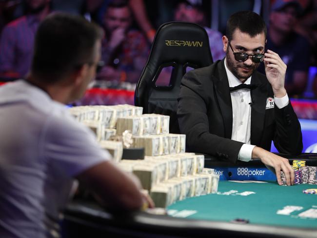 Dario Sammartino, right, of Italy, looks at Hossein Ensan, of Germany, as they play a hand at the final table of the World Series of Poker main event, Tuesday, July 16, 2019, in Las Vegas. (AP Photo/John Locher)