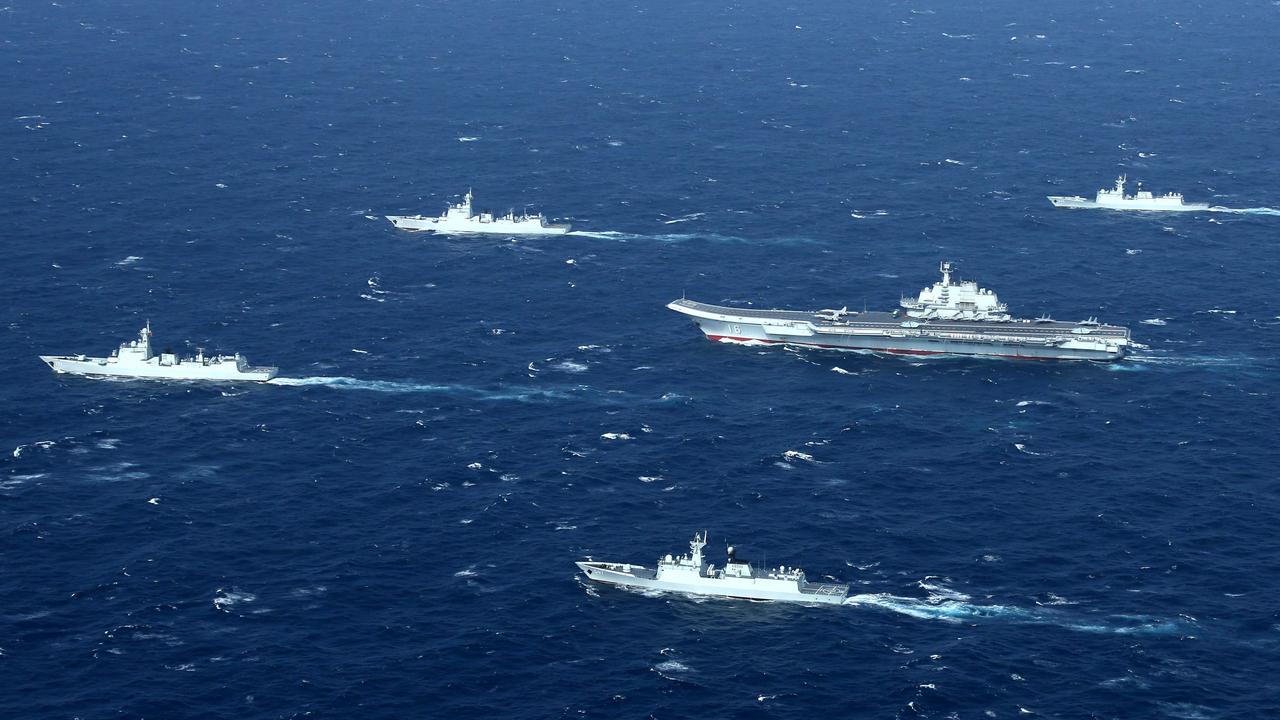 A Chinese Navy formation, including the aircraft carrier Liaoning (C), during military drills in the South China Sea where tensions are brewing. Picture: STR/AFP/China OUT.