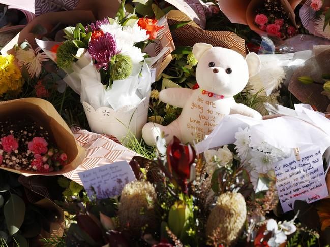 Floral tributes at the scene of the horrific bus crash, which killed 10 people and injured 25 others at Greta in the Hunter wine country. Picture: Jonathan Ng