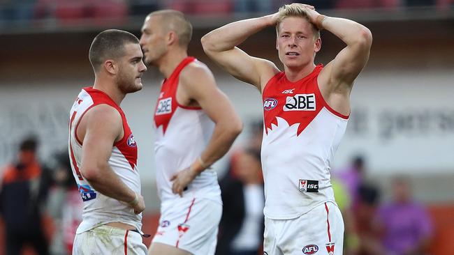 A shattered Isaac Heeney, Tom Papley and Sam Reid after Sydney’s narrow loss. Picture: Phil Hillyard