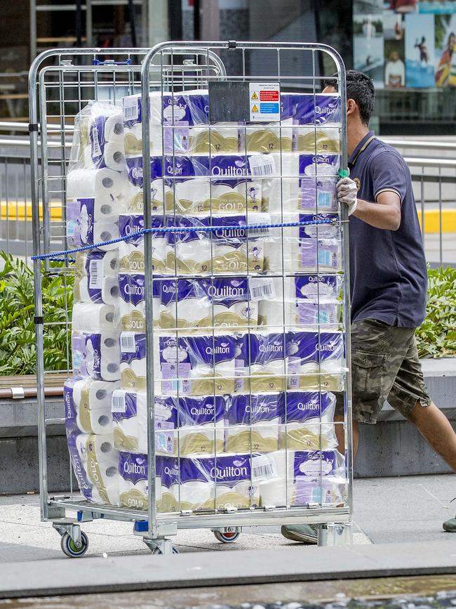 A man with a stack of toilet paper in Surfers Paradise. Picture: Jerad Williams