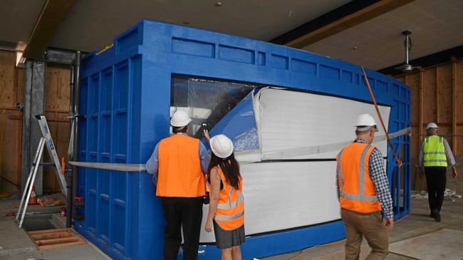 Mayor Andrew Willcox and senior communications officer Lisa Maher taking a sneak peek inside the new aquarium, which will be home to 30 different species of fish. When finished, the exterior will have wooden panelling. Picture: Georgia Simpson