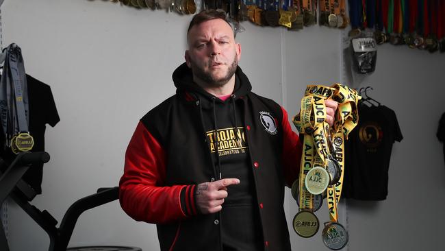 Darran Petty with medals won by himself and other members of Trojan Academy at the recent national jiu jitsu titles. Picture: Nikki Davis-Jones