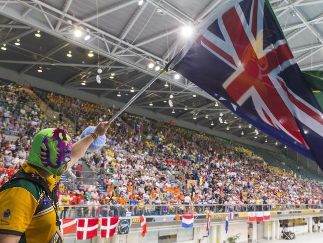 A supporter waves the Australian flag during the Swimming event. Picture: AAP Image/Craig Golding