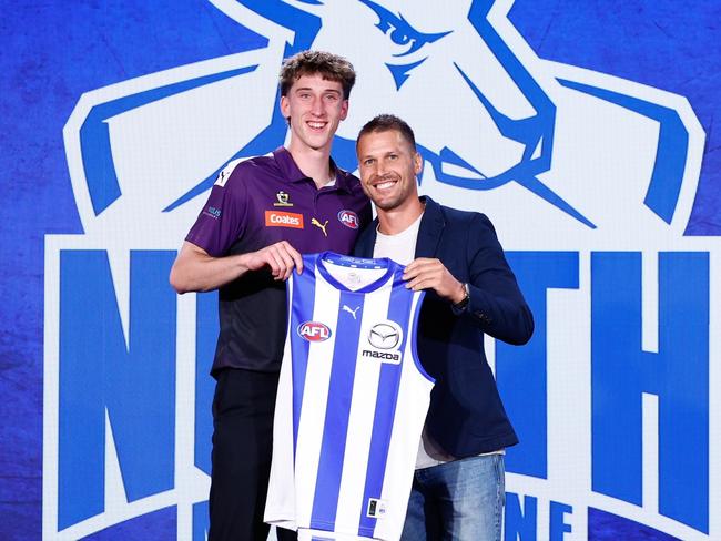 Matt Whitlock receives his jumper from Andrew Swallow. Picture: Michael Willson/AFL Photos via Getty Images