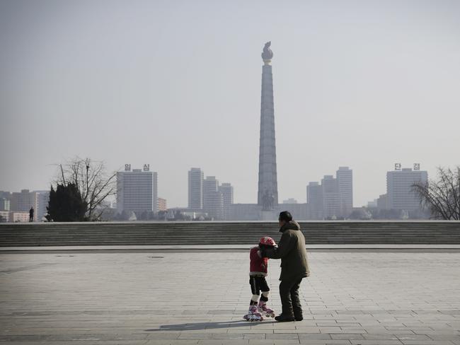 A North Korean girl learns to rollerblade on Kim Il Sung Square in Pyongyang, with the Juche Tower in the background. Picture: Wong Maye-E/AP