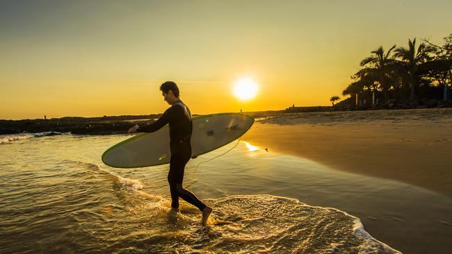 A surfer heads out at sunrise at Snapper Rocks. (Pic: Nigel Hallett)