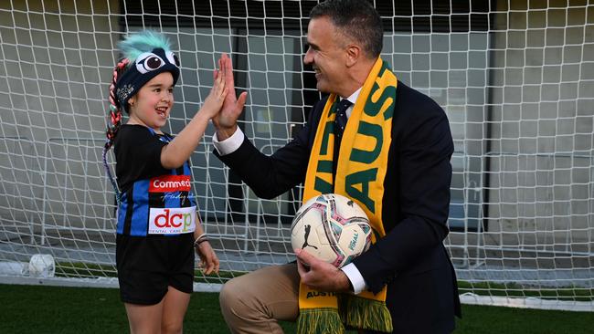 Premier Peter Malinauskas high-fives Gisela Moro, 6, at Adelaide Comets FC. Picture: NCA NewsWire / Naomi Jellicoe