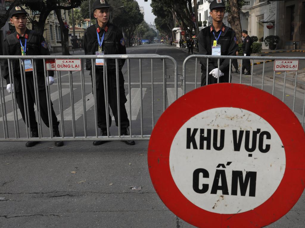 Police officers stand guard outside Metropole Hotel where Mr Trump and Kim had dinner. Picture: AP