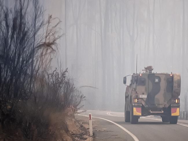 MALLACOOTA  AUSTRALIA - JANUARY 15:  Australian Defence Force  (ADF) Armoured vehicle personnel carrier is seen on the prince Highway near Mallacoota on January 15, 2020 , Australia. The Princes Highway between Mallacoota and Orbost remains closed to public due to the risk of falling trees following the devastating bushfires that have swept through East Gippsland in recent weeks. ADF armoured vehicles have been travelling the stretch of road to bring supplies in to Mallacoota, after the coastal town was cut off by fire on New Years Eve, forcing residents and holidaymakers to shelter on the beach. More than 1500 people were evacuated by Navy ships and helicopters to Melbourne in the following week.  Fires continue to burn across East Gippsland, with firefighters working to contain a number of blazes in the region. Four people have died and more than 1.3m hectares have been burned across the state following weeks of ongoing fires. (Photo by Luis Ascui/Getty Images)