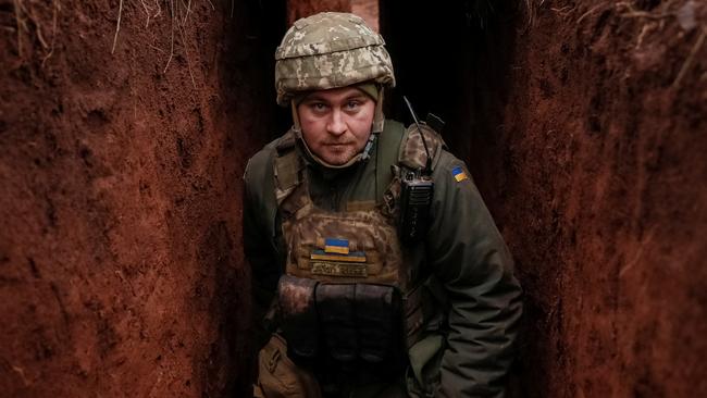 A Ukrainian soldier in a trench on the frontline near the city of Novoluhanske in the Donetsk region, Ukraine. Picture: Reuters