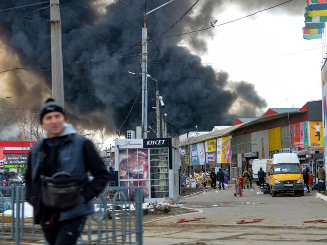 Black smoke rises into the sky from the Barabashovo market. Picture: AFP