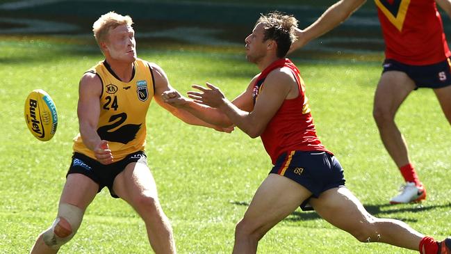 Cameron Sutcliffe fires off a handball in the SANFL v WAFL state game. Picture: Paul Kane/Getty Images