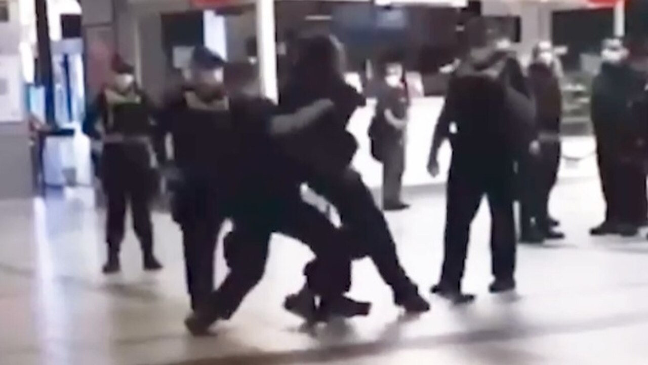 A police officer has been charged with assault for a tackle on a man at Flinders Street Station.