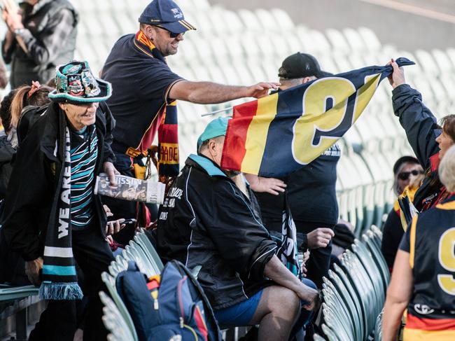 Crows and Port Adelaide fans sitting together on the southern side of Adelaide Oval early this morning to be extras in film "Never Too Late", directed by Roy Billing, Thursday, April 11, 2019. (Photo by Morgan Sette/ The Advertiser)