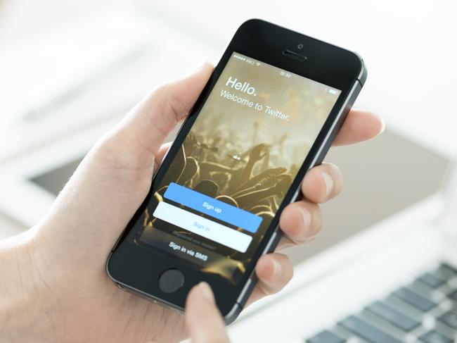 KIEV, UKRAINE - JUNE 27, 2014: Person holding a brand new Apple iPhone 5S with Twitter app login page on the screen. Twitter is a social media online service for microblogging and networking, founded in March 21, 2006.