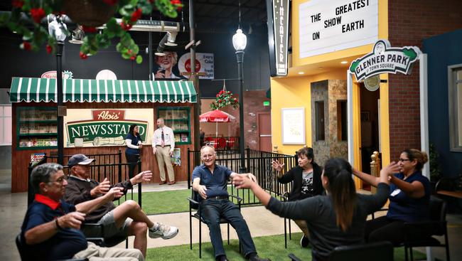 An exercise class in courtyard of Glenner Town Square, a US aged-care facility that uses reminiscence therapy. Music, recipes and photos can also trigger memories.    Picture: The Wall Street Journal