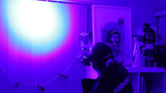 Police perform luminol testing inside the Lurnea granny flat. Picture: NSW Police.