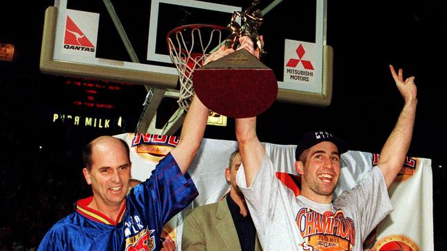 Former Adelaide 36ers coach Phil Smyth and player Brett Maher celebrate their 2008 NBL premiership at the Powerhouse – now Titanium Security Arena