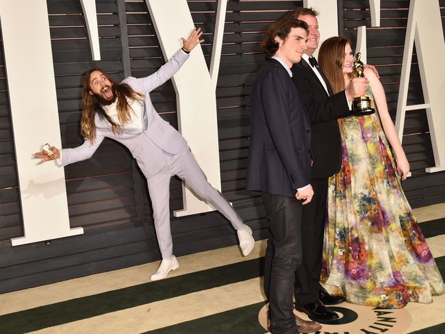 Jared Leto photobombs producer James W. Skotchdopole at the Vanity Fair Oscar Party.