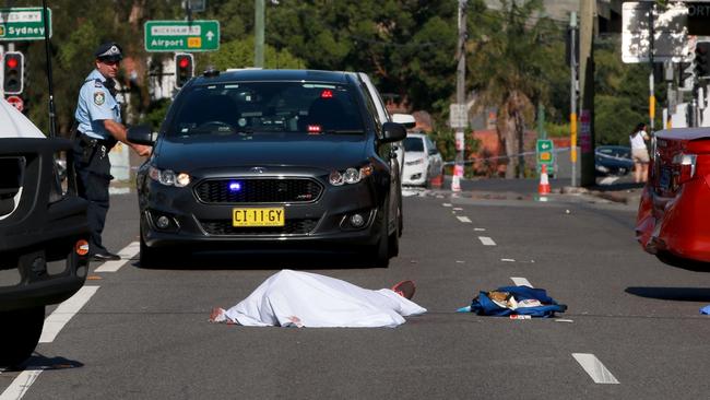 The body of a man lies in the middle of Forest Road and Wardell Street in Arncliffe. Picture by Damian Shaw