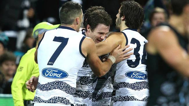 Patrick Dangerfield, Harry Taylor and James Parsons celebrate the winning goal. Picture: Wayne Ludbey