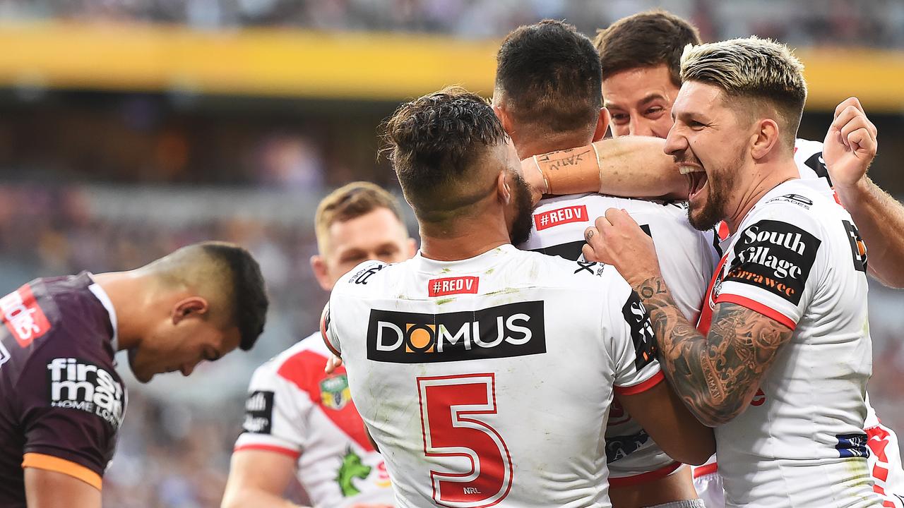 Dragons players celebrate a Tariq Sims try.