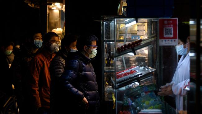 People que at a food stall in Shanghai. Picture: AFP