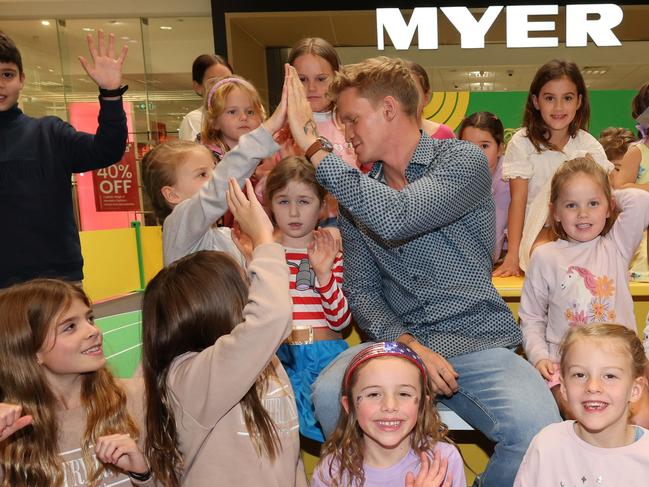 Kids pose for a photo with Cody Simpson at a meet-and-greet at Robina Town Centre outside Myer . Picture Glenn Hampson