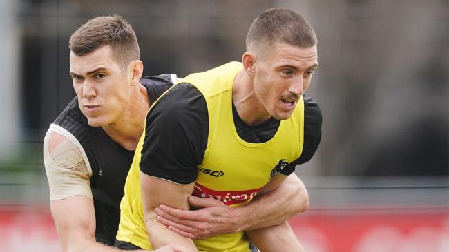 Mason Cox of the Magpies tackles Darcy Cameron of the Magpies during an AFL Collingwood Magpies training session at Holden Centre in Melbourne, Tuesday, June 16, 2020. (AAP Image/Michael Dodge) NO ARCHIVING