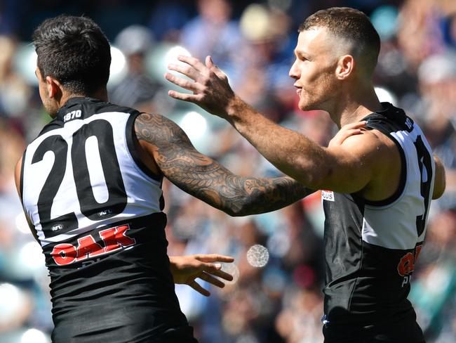 Robbie Gray and Chad Wingard celebrate a goal.