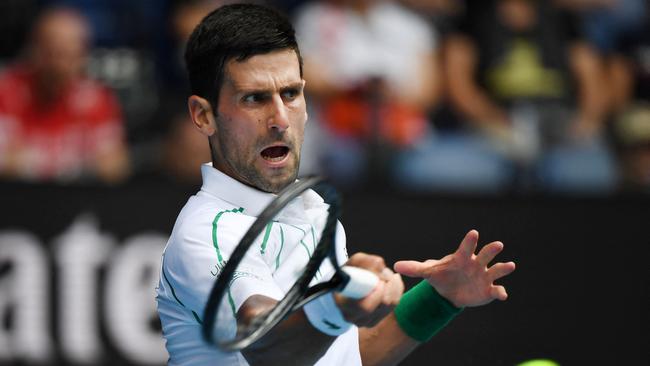 Djokovic hitting a return against Argentina's Diego Schwartzman during their men's singles match of the Australian Open in 2021 Picture: Manan Vatsyayana/AFP