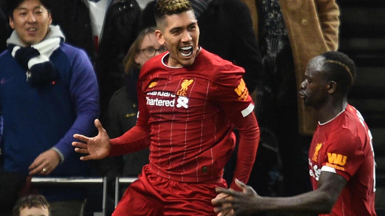 Liverpool's Brazilian midfielder Roberto Firmino (L) celebrates scoring the opening goal during the English Premier League football match between Tottenham Hotspur and Liverpool at Tottenham Hotspur Stadium in London, on January 11, 2020. (Photo by Glyn KIRK / AFP) / RESTRICTED TO EDITORIAL USE. No use with unauthorized audio, video, data, fixture lists, club/league logos or 'live' services. Online in-match use limited to 120 images. An additional 40 images may be used in extra time. No video emulation. Social media in-match use limited to 120 images. An additional 40 images may be used in extra time. No use in betting publications, games or single club/league/player publications. /