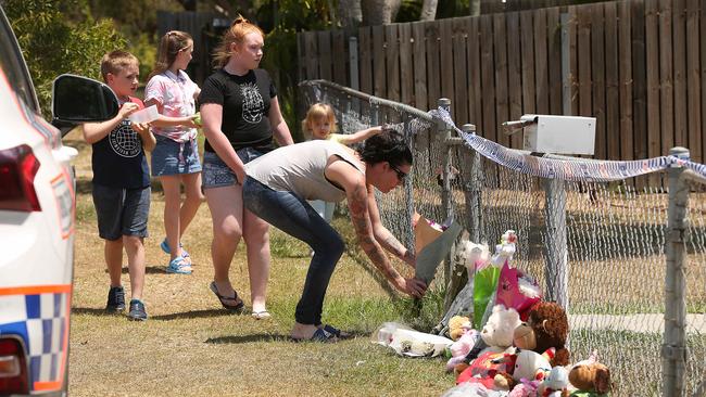 A woman and children place flowers at a memorial for the two toddlers. Picture: Lyndon Mechielsen/The Australian