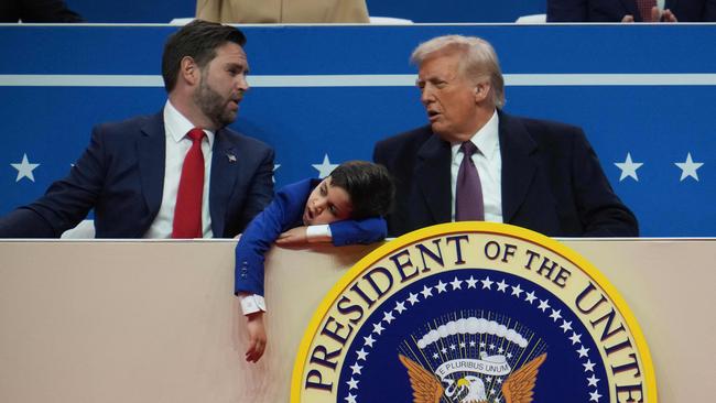 US Vice President JD Vance, his son Ewan, 7, and US President Donald Trump Trump talk during an indoor inauguration parade at Capital One Arena. Picture: Getty Images/AFP